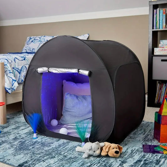 A black, opaque tent with a mesh side panel, providing a calming, sensory-friendly environment for individuals seeking relief from external stimuli.